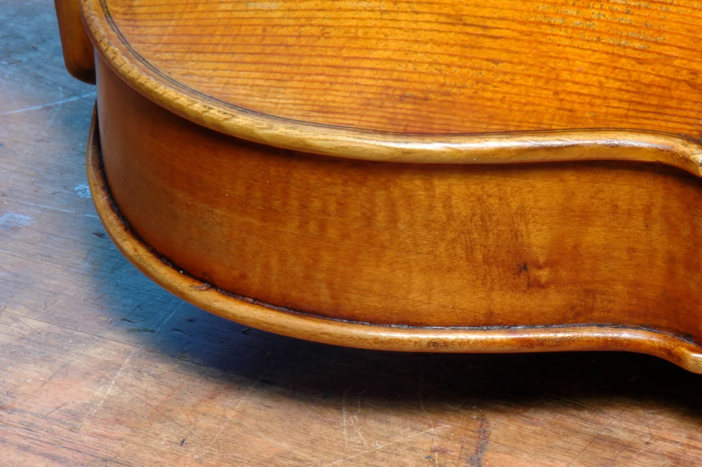 The lower rib and corner of an instrument under restoration.